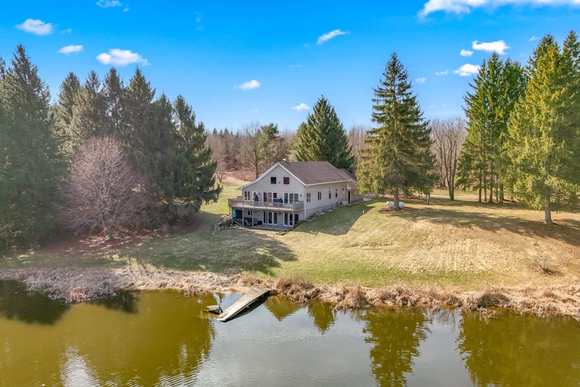 ONE OF A KIND....Tucked off the road for privacy, this 56-acre - Beach Home for sale in Osseo, Michigan on Beachhouse.com