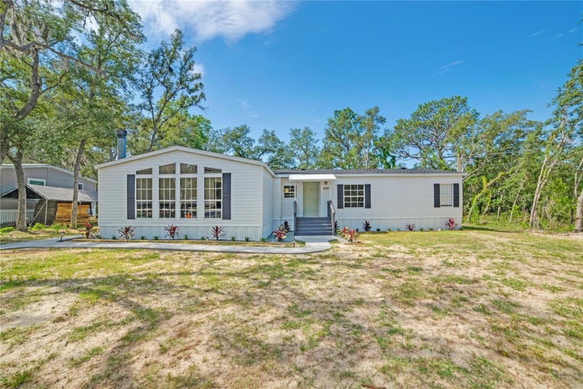 This spacious triple-wide home boasts an abundance of natural - Beach Home for sale in Homosassa, Florida on Beachhouse.com