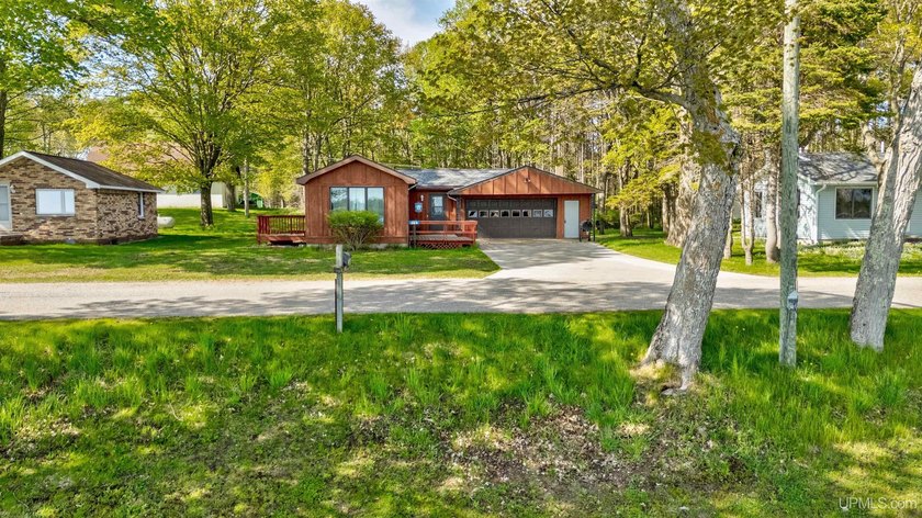 Welcome to life on Indian Lake, where wide-open water views - Beach Home for sale in Manistique, Michigan on Beachhouse.com