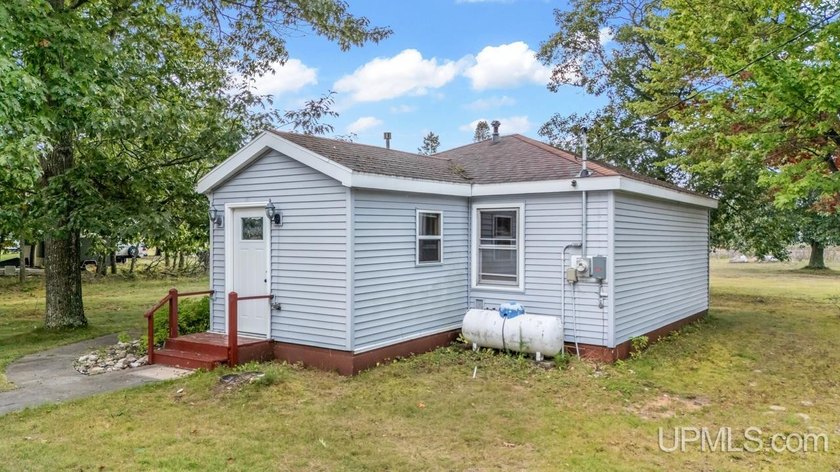 Welcome to your riverside retreat featuring 100' of frontage on - Beach Home for sale in Rapid River, Michigan on Beachhouse.com