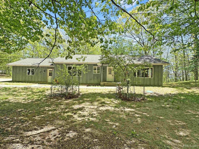 Situated on a scenic 2.47-acre bluff-edge lot, this - Beach Home for sale in Gladstone, Michigan on Beachhouse.com