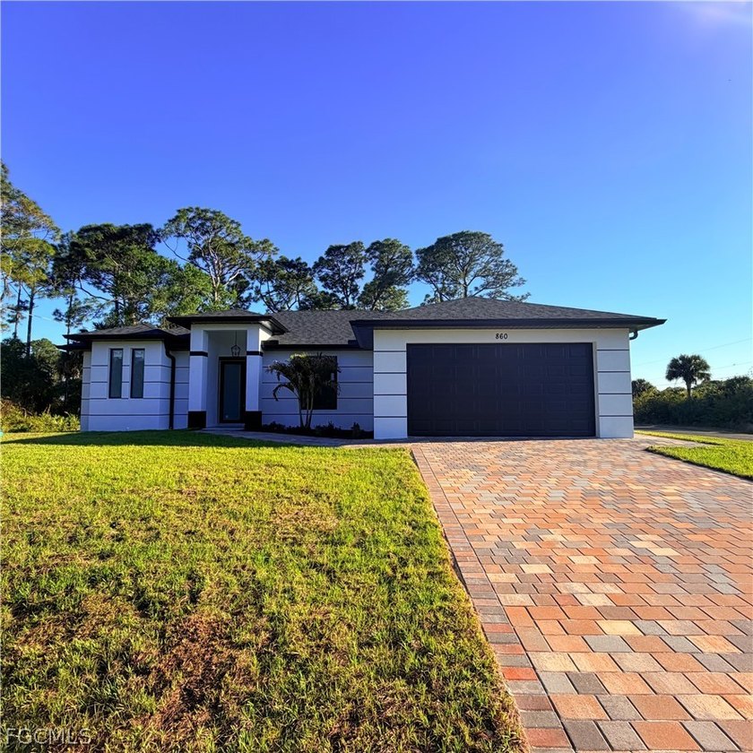 This stunning new-construction home blends modern elegance with - Beach Home for sale in Lehigh Acres, Florida on Beachhouse.com