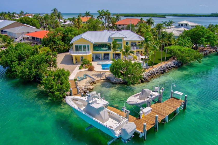 Nestled on a lushly landscaped, gated point lot, this elegant - Beach Home for sale in Duck Key, Florida on Beachhouse.com