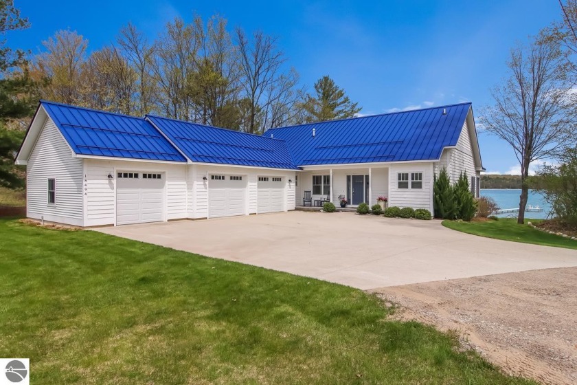 This remarkable home is situated on the peaceful shoreline of - Beach Home for sale in Traverse City, Michigan on Beachhouse.com