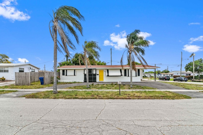 Nestled on a prime corner lot this delightful single-family home - Beach Home for sale in Riviera Beach, Florida on Beachhouse.com