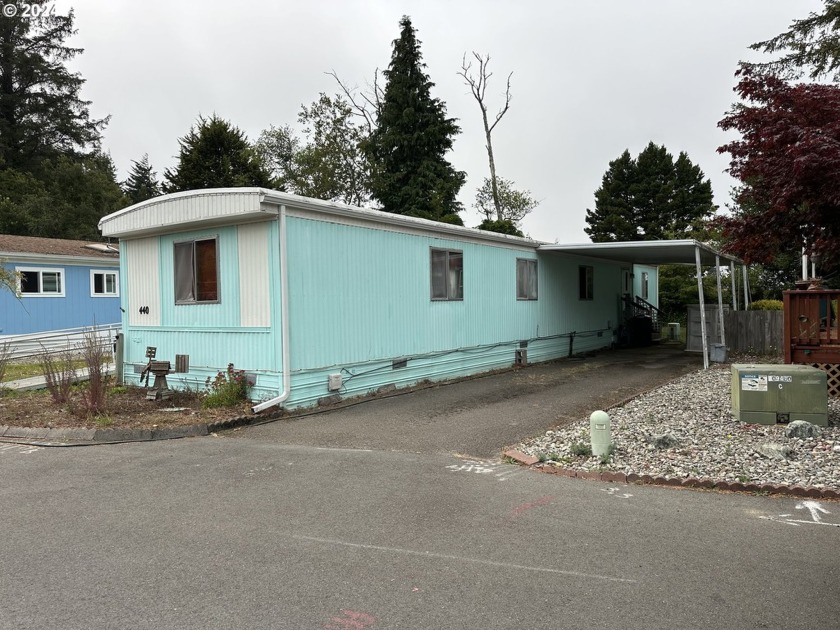 Situated in the beautiful Shore Pines Mobile Home Park, this - Beach Home for sale in Coos Bay, Oregon on Beachhouse.com