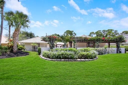 A bougainvillea covered trellis with a fountain entranceway - Beach Home for sale in Palm Beach Gardens, Florida on Beachhouse.com