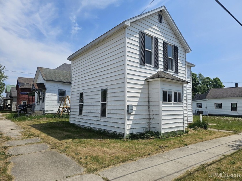 Calling all fixer upper enthusiasts! City home, situated on a - Beach Home for sale in Manistique, Michigan on Beachhouse.com