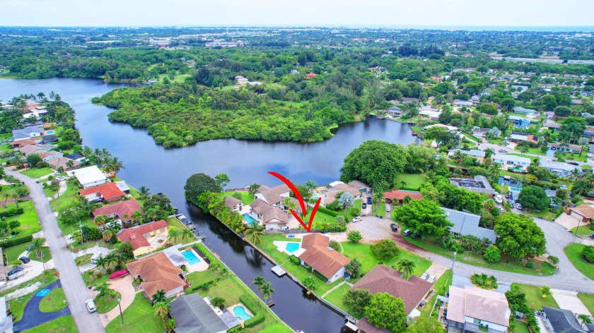 Stunning Waterfront Retreat with Private Dock!  This hidden gem - Beach Home for sale in Lake Worth, Florida on Beachhouse.com