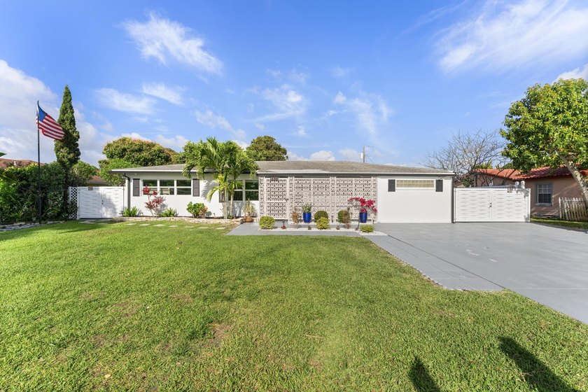 Welcome to this exceptional 3-bedroom, 3-bathroom home in highly - Beach Home for sale in Lake Clarke Shores, Florida on Beachhouse.com