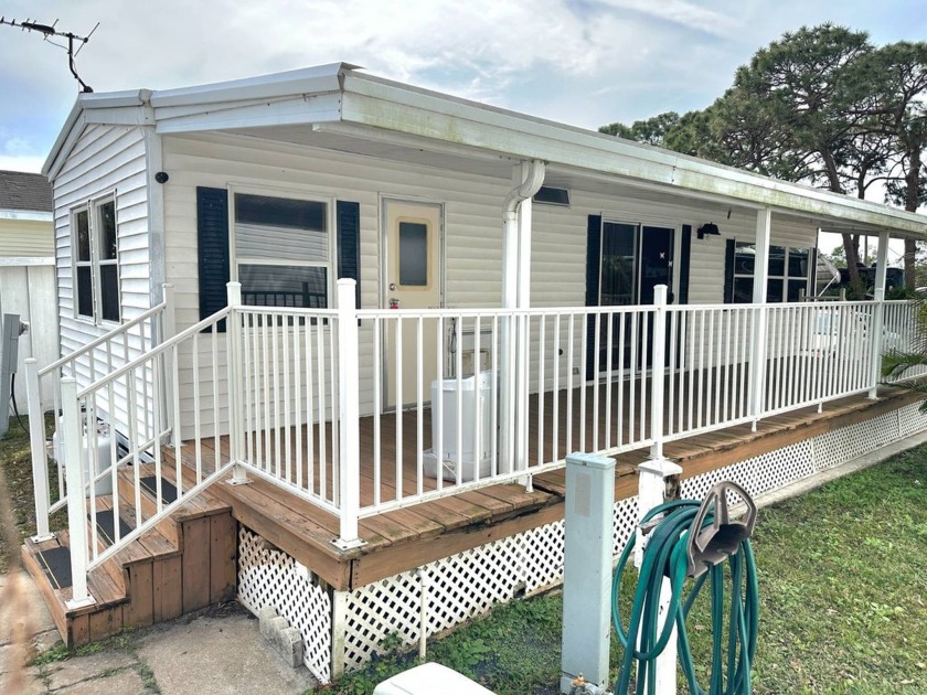 PRETTY LAKEFRONT  HOME with a covered deck.   (no flooding here) - Beach Home for sale in Largo, Florida on Beachhouse.com