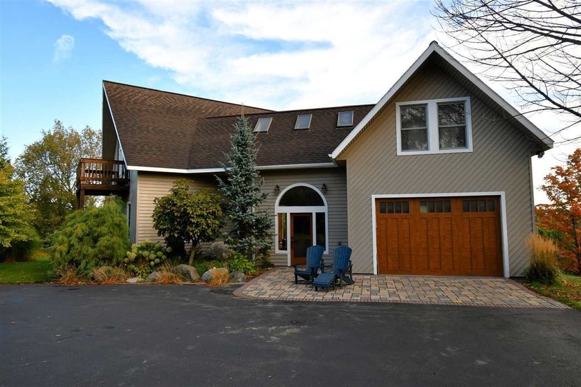 This four-bedroom, three-bath home is conveniently located just - Beach Home for sale in Charlevoix, Michigan on Beachhouse.com