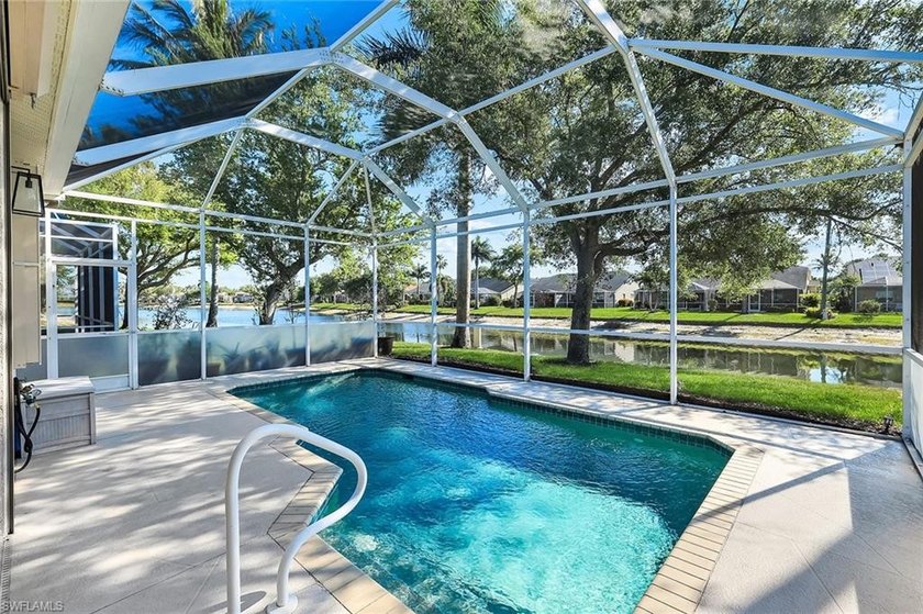 Positioned along a freshwater lake, the screened pool terrace - Beach Home for sale in Naples, Florida on Beachhouse.com