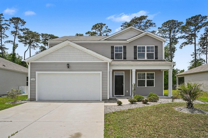 Situated on a quiet lot overlooking a wooded area, this - Beach Home for sale in Little River, South Carolina on Beachhouse.com