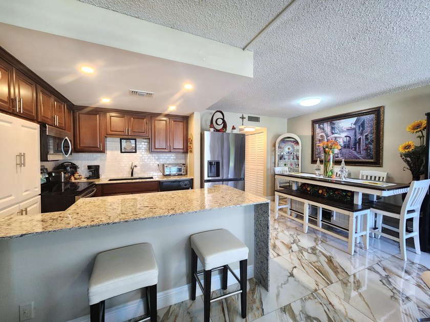 Experience the convenience of first floor in this spacious and - Beach Condo for sale in Deerfield Beach, Florida on Beachhouse.com