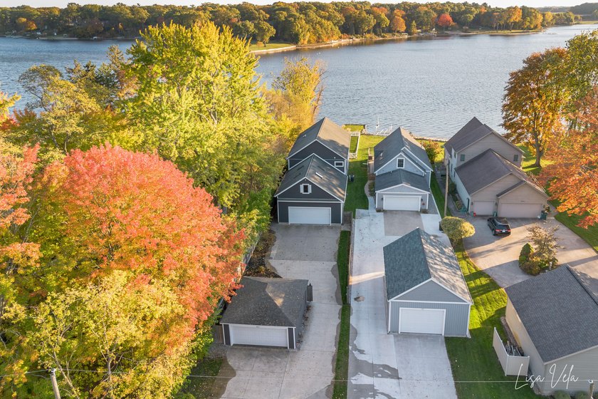 Stunning 5 bedroom executive home on Mona Lake! Welcome to your - Beach Home for sale in Norton Shores, Michigan on Beachhouse.com