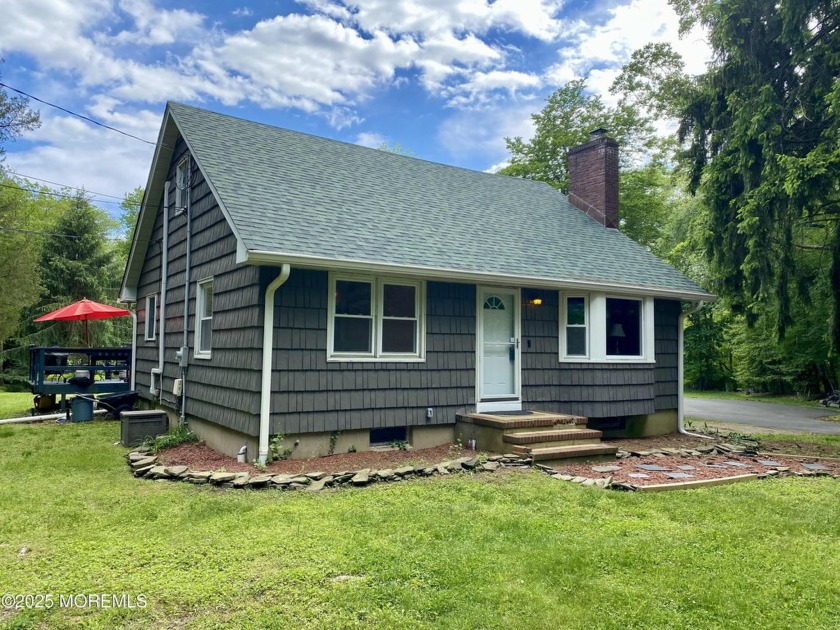 Enjoy peace and privacy in this charming Cape Cod-style home on - Beach Home for sale in Wall, New Jersey on Beachhouse.com
