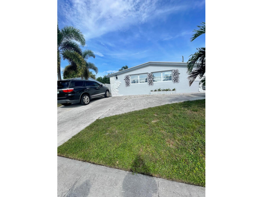 Step into this beautifully renovated single-family home in Palm - Beach Home for sale in Palm Beach Gardens, Florida on Beachhouse.com