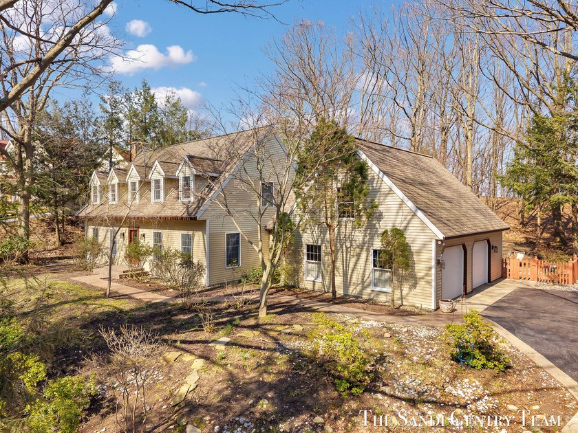 Tucked into a peaceful, wooded setting on 2.7 acres, this - Beach Home for sale in Grand Haven, Michigan on Beachhouse.com