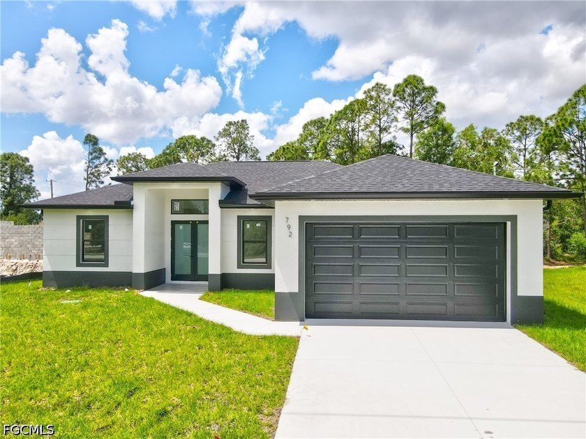 Stunning brand-new home located on a desirable corner lot with a - Beach Home for sale in Lehigh Acres, Florida on Beachhouse.com