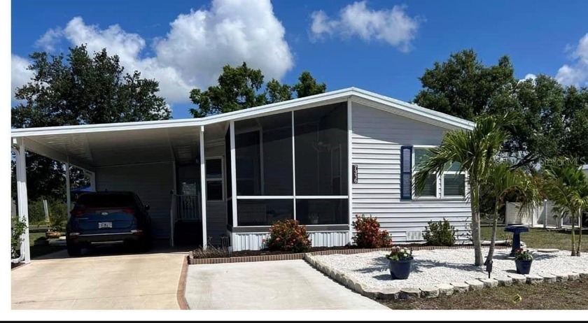 Welcome to the Village of Holiday Lake, an active WATERFRONT - Beach Home for sale in Port Charlotte, Florida on Beachhouse.com