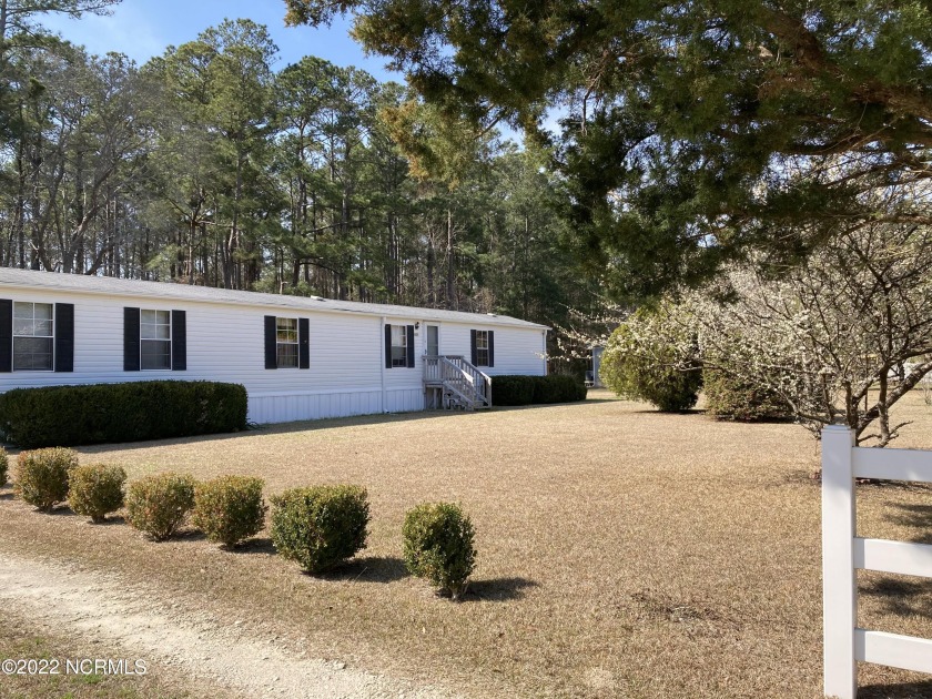 This well maintained home sits on beautifully landscaped grounds - Beach Home for sale in Supply, North Carolina on Beachhouse.com