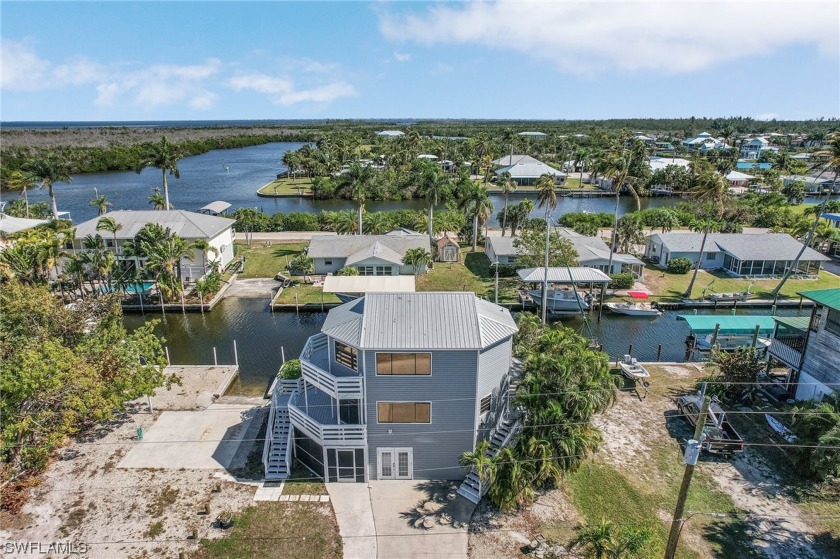 This 3-story waterfront, sailboat access, home comes with a 2nd - Beach Home for sale in Bokeelia, Florida on Beachhouse.com
