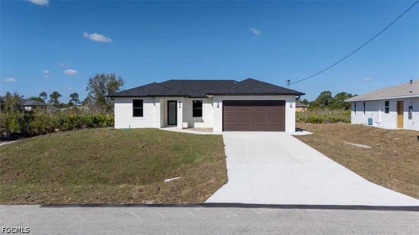 Welcome to this beautifully crafted new-construction home that - Beach Home for sale in Lehigh Acres, Florida on Beachhouse.com