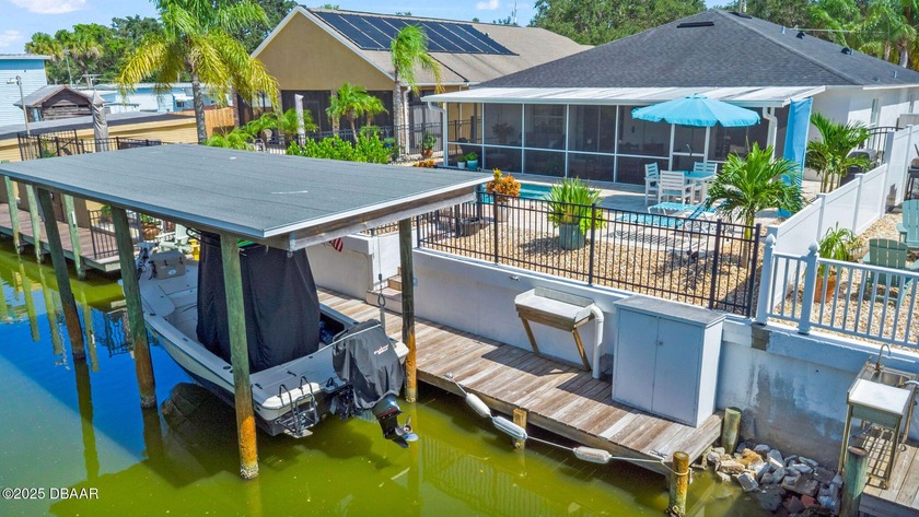CANAL-FRONT PARADISE WITH POOL AND BOATHOUSE WITH LIFT!  ALLOWED - Beach Home for sale in Edgewater, Florida on Beachhouse.com