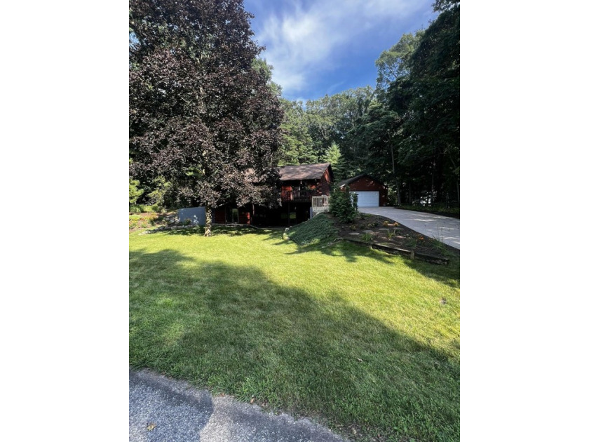 Step into this inviting 3-bedroom, 2.5-bath log home nestled on - Beach Home for sale in Saugatuck, Michigan on Beachhouse.com