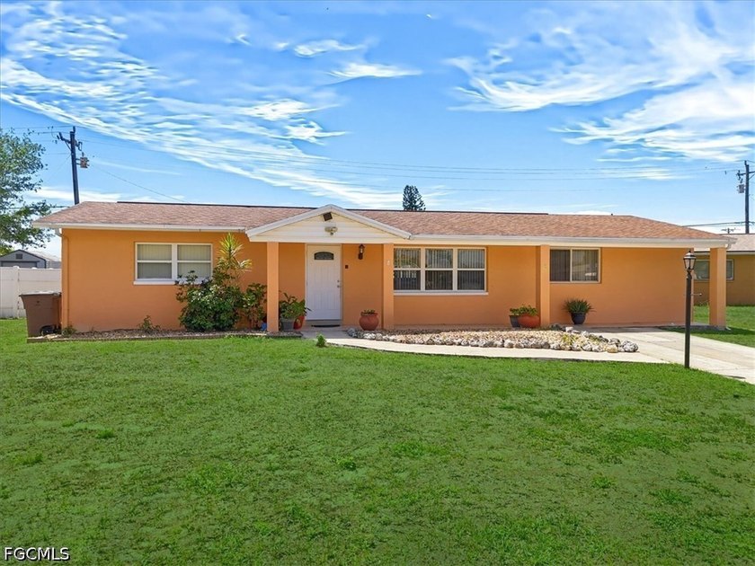 Set along a canal in Lehigh Acres, this 3-bedroom, 2-bath home - Beach Home for sale in Lehigh Acres, Florida on Beachhouse.com