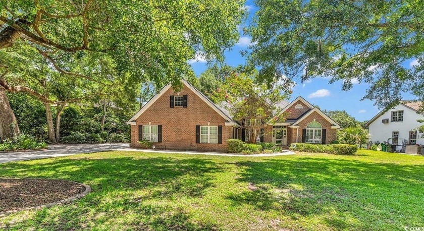 Nestled beneath mature oaks, this custom all-brick home offers a - Beach Home for sale in Murrells Inlet, South Carolina on Beachhouse.com