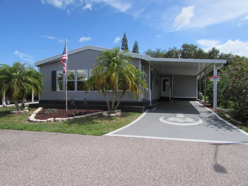 Enter from the decoratively coated driveway under the carport - Beach Home for sale in Trinity, Florida on Beachhouse.com