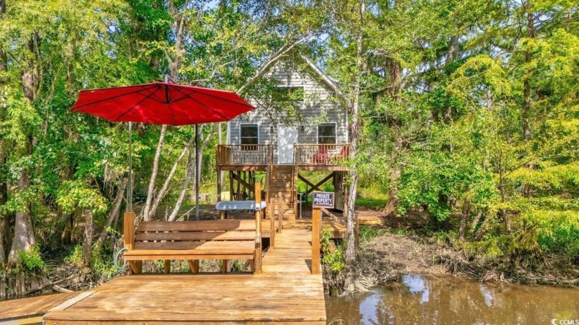 Accessible only by boat, this beautiful home is nestled along - Beach Home for sale in Pawleys Island, South Carolina on Beachhouse.com