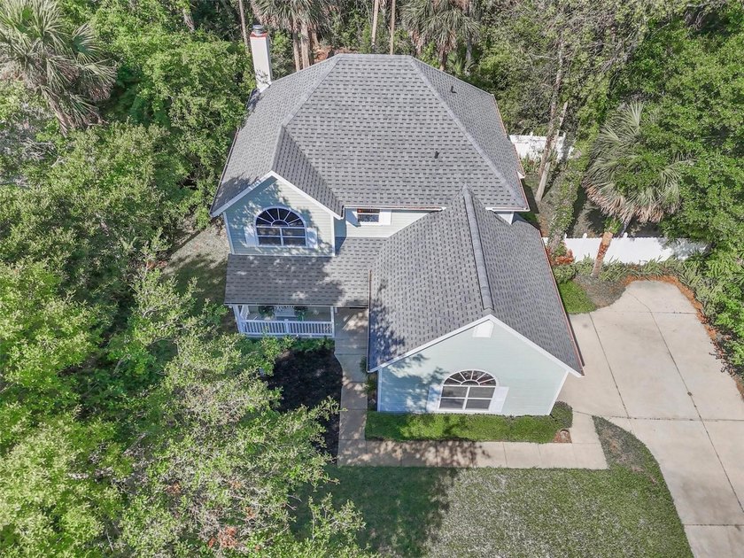 Tucked beneath a canopy of mature trees in the gated community - Beach Home for sale in Flagler Beach, Florida on Beachhouse.com