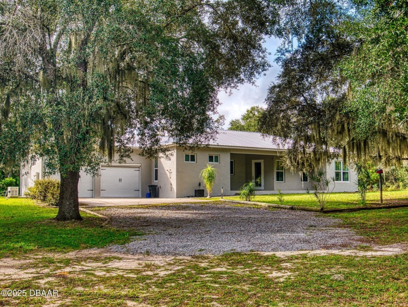 Country living meets modern convenience in this serene wooded - Beach Home for sale in New Smyrna Beach, Florida on Beachhouse.com