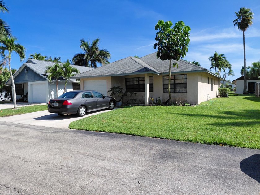 Beautiful home featuring a modern kitchen with white cabinets - Beach Home for sale in West Palm Beach, Florida on Beachhouse.com