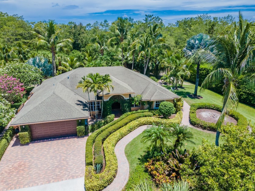 A landscaper's dream! Behind the custom wrought iron gates sits - Beach Home for sale in West Palm Beach, Florida on Beachhouse.com