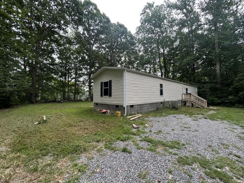 Rare waterfront find! This home sits on a wooded lot that offers - Beach Home for sale in Kilmarnock, Virginia on Beachhouse.com
