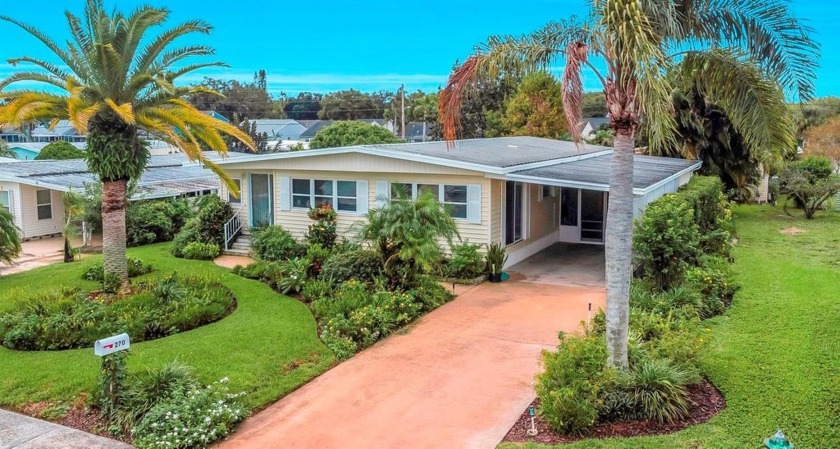 Enter the home, viewing lush gardens, then wonder as you enter - Beach Home for sale in Palm Harbor, Florida on Beachhouse.com