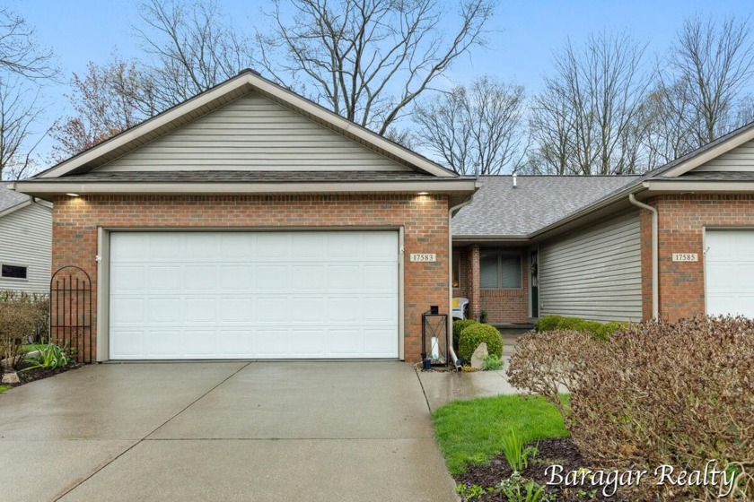 Nestled in a serene setting, this charming and spacious end-unit - Beach Condo for sale in Spring Lake, Michigan on Beachhouse.com