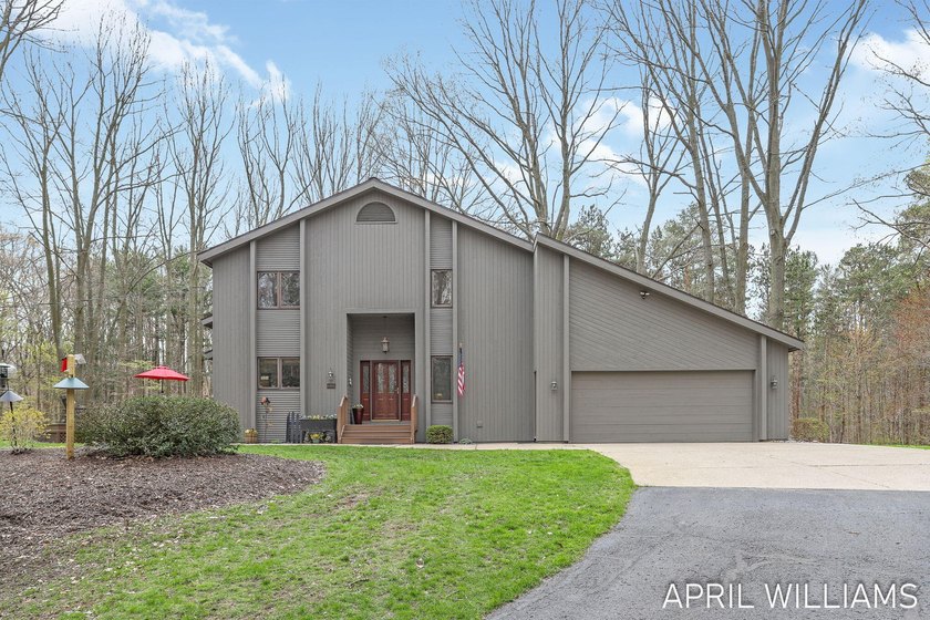 Less than a mile from the sandy shores of Lake Michigan, this - Beach Home for sale in West Olive, Michigan on Beachhouse.com