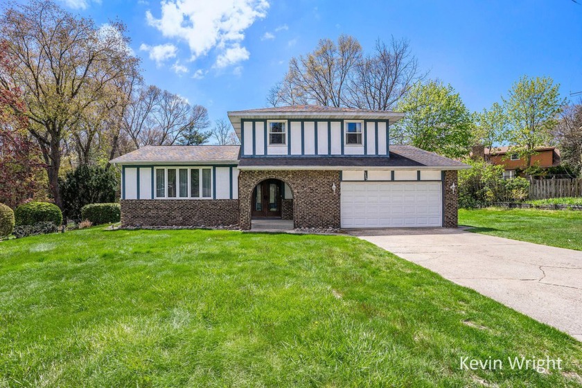 Welcome to this spacious 4-bedroom, 2 full bath bi-level home in - Beach Home for sale in Spring Lake, Michigan on Beachhouse.com