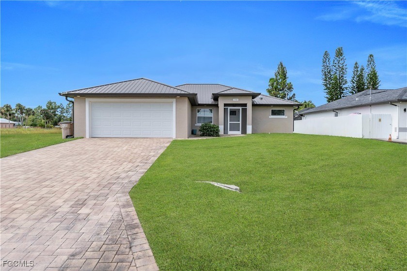 Beautiful 2023-built home with a metal roof and a peaceful canal - Beach Home for sale in Lehigh Acres, Florida on Beachhouse.com