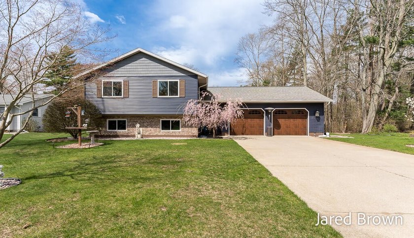 Welcome to this well-maintained home nestled on a nearly - Beach Home for sale in Spring Lake, Michigan on Beachhouse.com
