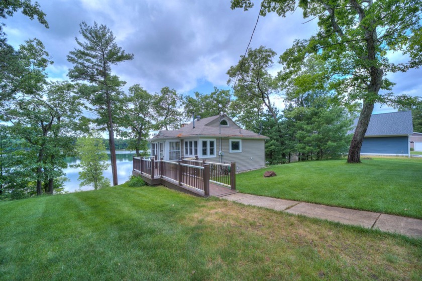 Stunning Waterfront Property on Crystal Lake. Enjoy 110 feet of - Beach Home for sale in Whitehall, Michigan on Beachhouse.com