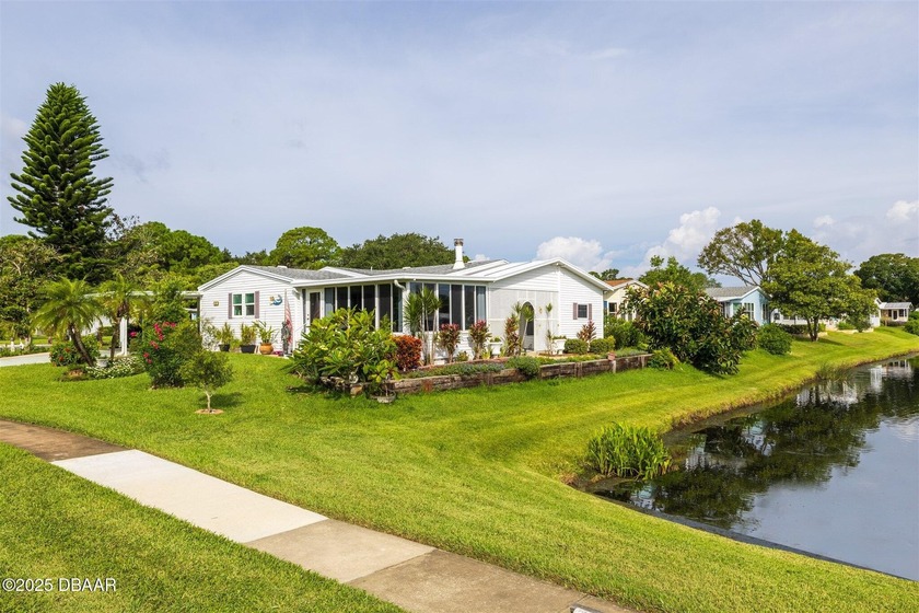 Step inside this rare waterside triple-wide Palm Harbor with - Beach Home for sale in Edgewater, Florida on Beachhouse.com