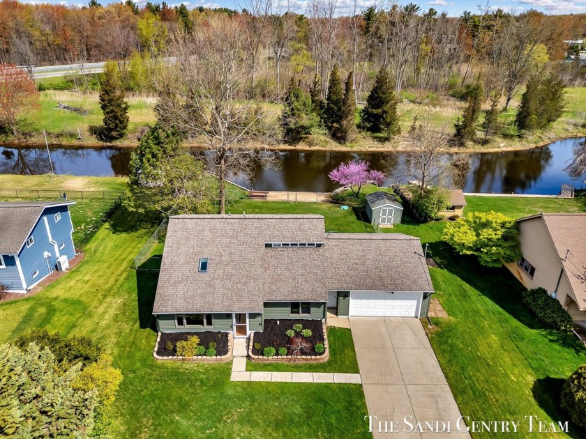 Welcome to this move-in-ready gem, offering 90 ft of serene - Beach Home for sale in Spring Lake, Michigan on Beachhouse.com