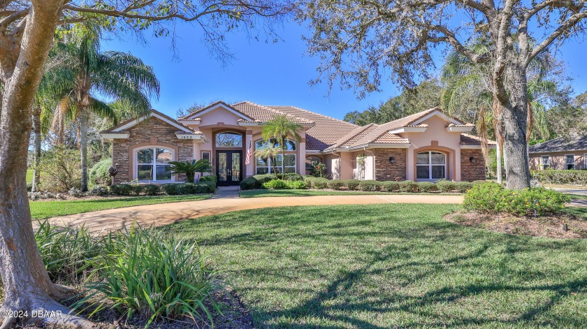A beautifully landscaped circular driveway leads to this - Beach Home for sale in Ormond Beach, Florida on Beachhouse.com