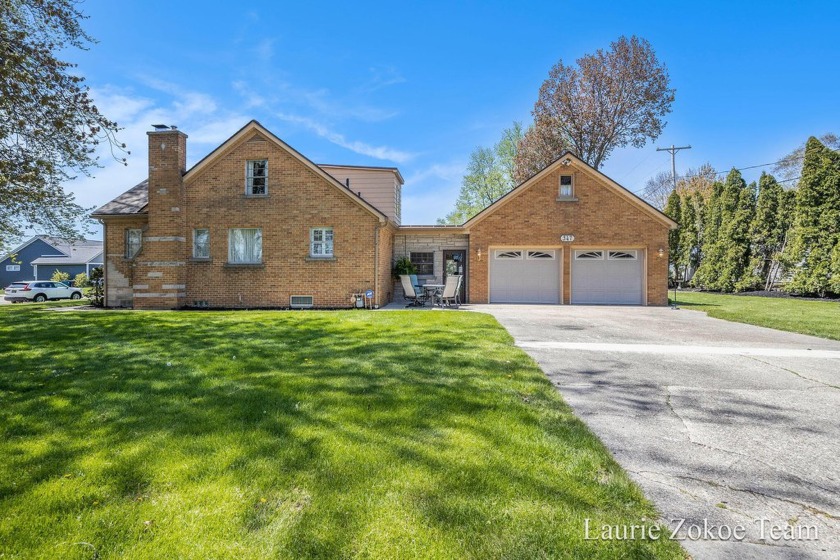 This charming brick home is with beautiful views of Lloyds Bayou - Beach Home for sale in Spring Lake, Michigan on Beachhouse.com